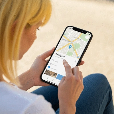 Person using a smartphone to search for local businesses, with a map overlay showing Avignon